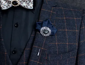 Elegant mens suit brooch lapel pin with dark blue fabric and crystal rhinestone design.