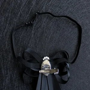 Men's formal suit bow tie back detail showing adjustable elastic strap and metal clip.