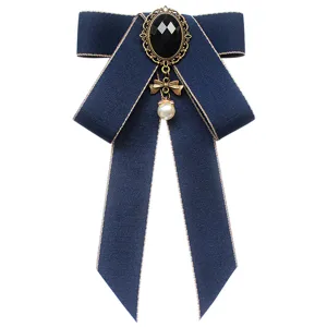 Classic navy blue JK uniform bow tie with vintage rhinestone and pearl drop for women.