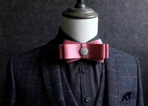 Detailed view of elegant wine red mens bow tie featuring dazzling rhinestone center decoration.