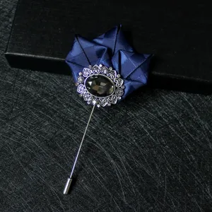Elegant men's lapel pin brooch featuring dark blue ribbon and crystal flower design for suits.
