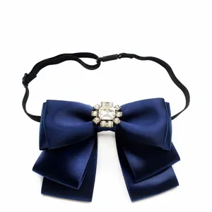 Elegant navy blue satin ribbon bow tie with sparkling crystal brooch and adjustable strap.