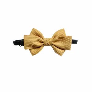 Detailed view of the yellow children bow tie with textured fabric and elastic band 12x7cm