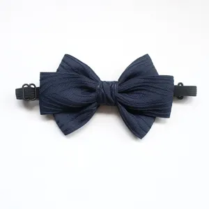 Dark blue kids bow tie detail, textured fabric with adjustable elastic strap for comfort.