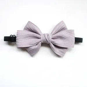Detailed view of the light purple children bow tie featuring textured fabric and elastic band.