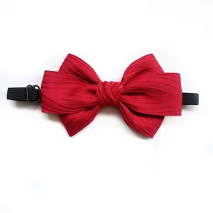 Red children's bow tie with elastic band detail view, simple and classic accessory for kids.
