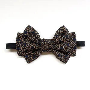Detailed close-up view of the exquisite blue and gold patterned bow tie with elastic strap.