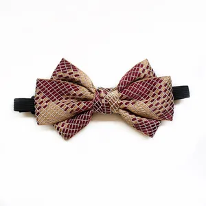 Close-up view of double layer woven bow tie featuring maroon gold grid pattern with elastic strap.