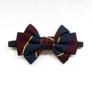Close-up detail of children's striped bow tie with elastic band, elegant navy and burgundy.