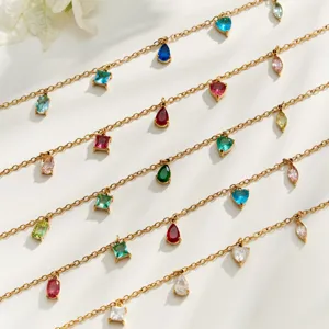 Multi-strand gold chain bracelet set with colorful crystal teardrop and geometric zircon pendants.