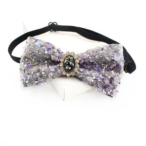 Detailed shot of sparkling gemstone and rhinestone bow tie with black elastic band, close up.