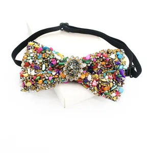 Detailed close-up of colorful gemstone and rhinestone bow tie with adjustable black strap.