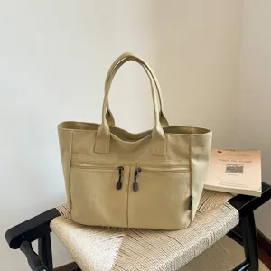 Japanese style casual canvas tote bag with dual front zipper pockets for daily commute.