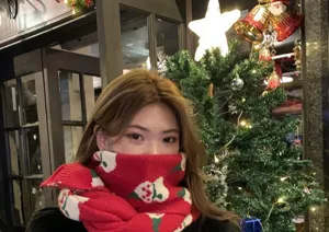 Red Christmas knitted scarf for women, cozy winter thermal snood with festive bell patterns.