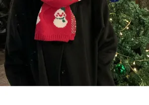 Christmas knitted winter scarf with cute snowman pattern, warm and festive accessory.