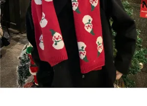 Christmas red knitted scarf detail showing festive snowman pattern and soft warm fabric texture