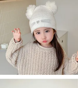 Kids winter knit beanie hat with cute double pom poms and soft warm material for toddlers.