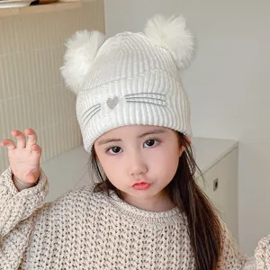 Children winter knitted beanie hat with dual pom poms and cute cat whiskers embroidery design.