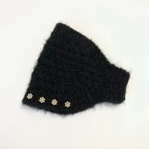 Detail view of black fuzzy knitted headband ear warmer, winter warm thick hair accessory.