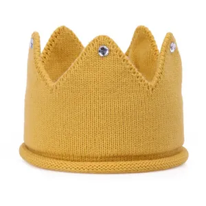 Detailed close-up of yellow knit baby crown headband with sparkling rhinestone accents.