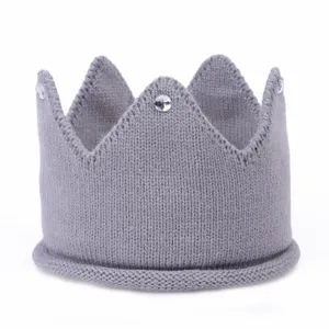 Close-up detail of grey knitted crown hairband with sparkly crystal rhinestones, soft texture.