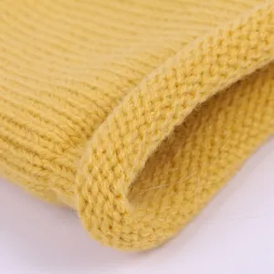 Macro detail of yellow knitted wool fabric showing soft ribbed texture for baby headband.