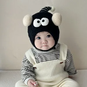 Cute baby plush hat with funny big eyes and earflaps, warm winter balaclava for infants.