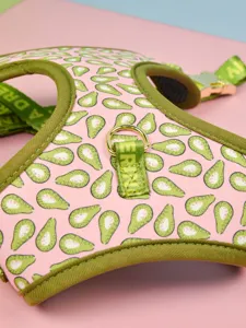 Close-up detail of cute avocado print pet harness with golden D-ring and olive green trim.
