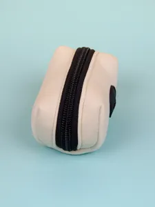 Neoprene dog waste bag dispenser detail shot, mini zipper pouch close up, pet accessory.