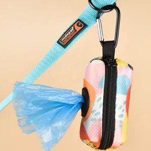 Close-up detail of a colorful abstract pattern pet poop bag dispenser with leash and carabiner.