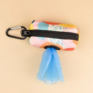 Detailed view of colorful abstract printed pet poop bag dispenser with black zipper hook.