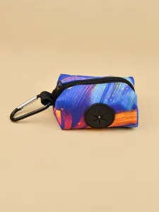 Detailed shot of portable pet waste bag dispenser with colorful abstract print and carabiner