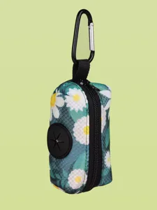 Close-up view of dog poop bag dispenser with floral print and metal carabiner hook.