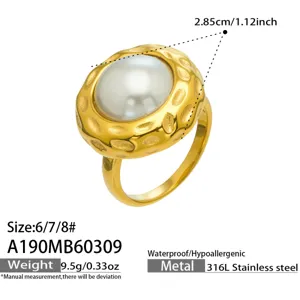 Detailed view of textured gold ring with white pearl, 316L stainless steel, size 6-8.