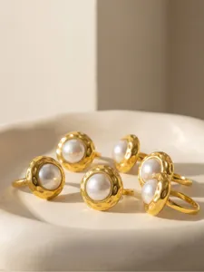 Detail view of textured gold stainless steel pearl ring, chic minimalist style open ring jewelry.