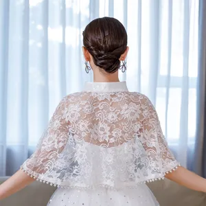 Detail view of white lace cape shawl with stand collar and pearl fringe for wedding or qipao outfits.