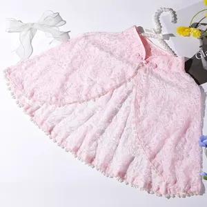 Pink lace cape detail showing delicate pearl trim and stand collar for elegant retro outfits.