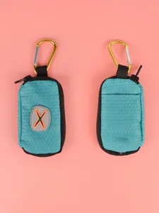 Detail view of portable pet waste bag dispenser, durable teal fabric holder with metal hook.