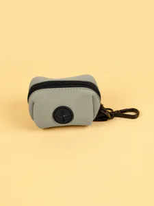 Portable neoprene dog waste bag dispenser with zipper and hook for daily walking.