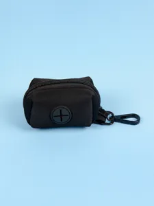 Close-up detail of the portable black neoprene dog waste bag dispenser with zipper and clip.