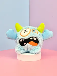 Close-up view of quirky cute plush monster toy featuring soft blue fabric and horns.
