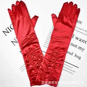 Red satin pleated long gloves detail view, elegant bridal wedding evening dress accessories.