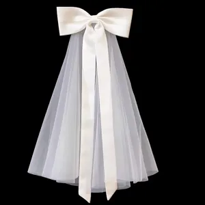 Detailed close-up view of elegant white satin bow with double layer mesh short bridal veil.