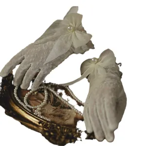 Vintage short lace mesh gloves with elegant sheer bow and pearl decoration for women wedding.