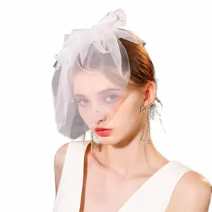 Short bridal veil with bow and rhinestones, minimalist wedding headpiece for outdoor brides.