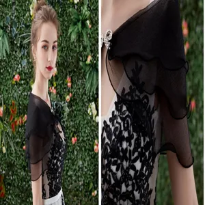 Black sheer bridal cape detail, delicate lace appliques, ruffled layers, elegant wedding accessory.