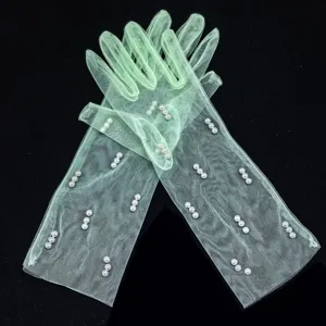 Detailed close-up shot of sheer mint green mesh gloves decorated with elegant white pearls.