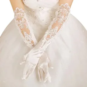 Close-up detail of long white lace bridal gloves, featuring delicate floral embroidery.