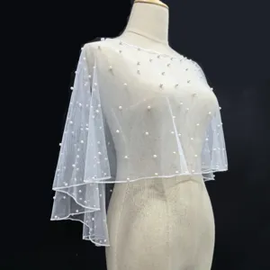 White sheer tulle pearl capelet close up, elegant bridal shoulder wrap wedding accessory.