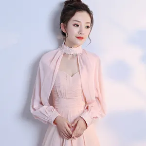 Detail view of pink chiffon long sleeve shrug, delicate lace stand collar, elegant evening wear.